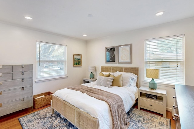 bedroom with recessed lighting and wood finished floors