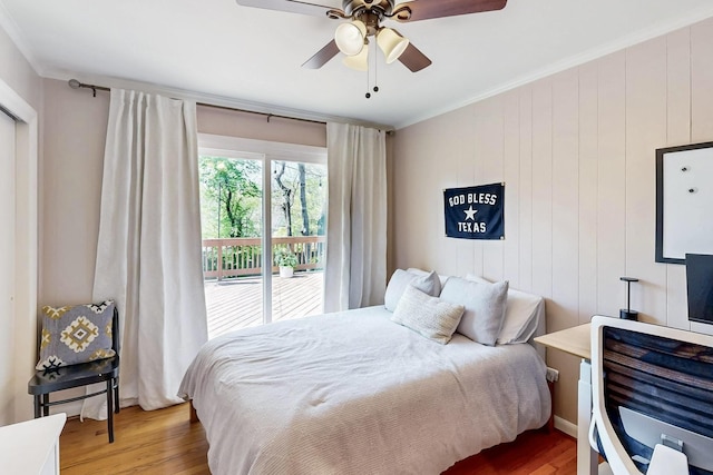 bedroom featuring wood finished floors, access to exterior, ceiling fan, and crown molding