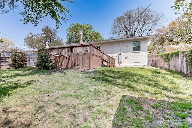 back of house featuring stairs, a lawn, a wooden deck, and a fenced backyard
