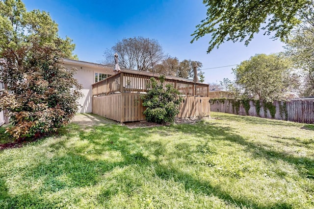 view of yard with fence and a deck