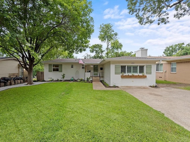 ranch-style house featuring a front lawn and a chimney