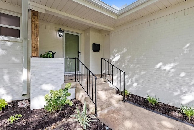 property entrance with brick siding