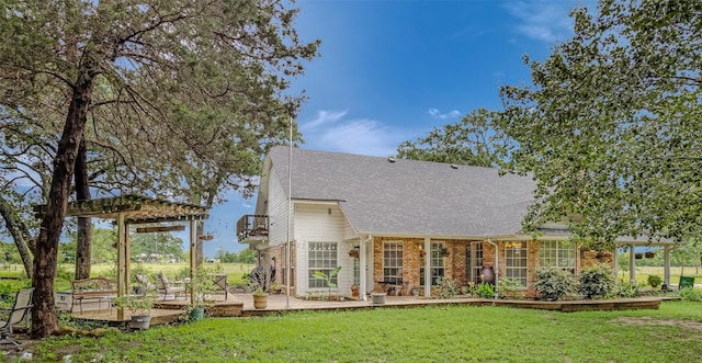130 Vz County Road 3509, Edgewood, TX 75117 - rear view of property featuring a deck, brick siding, a pergola, a shingled roof, and a lawn