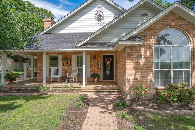 130 Vz County Road 3509, Edgewood, TX 75117 - view of front of home featuring a chimney, a porch, brick siding, and roof with shingles