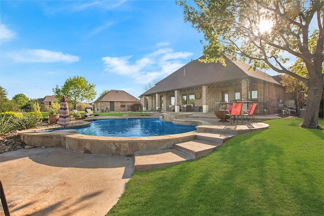 pool featuring a patio and a lawn