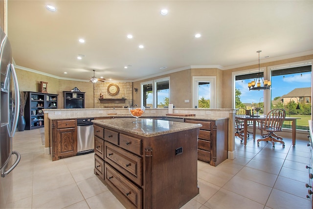 kitchen featuring a large island, ceiling fan with notable chandelier, stainless steel fridge, and recessed lighting