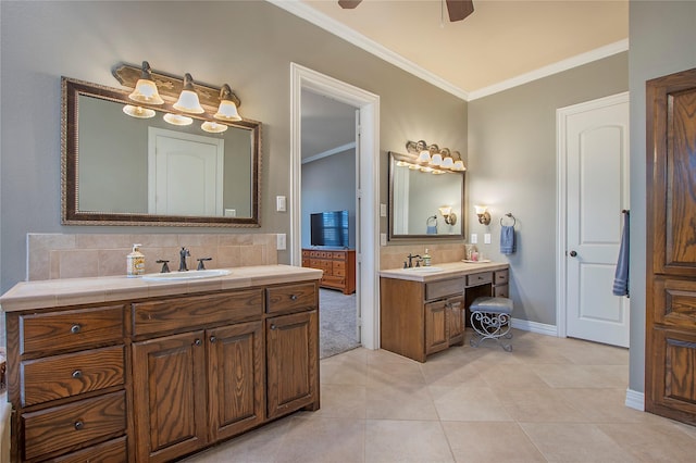 bathroom with tasteful backsplash, a sink, ceiling fan, crown molding, and two vanities