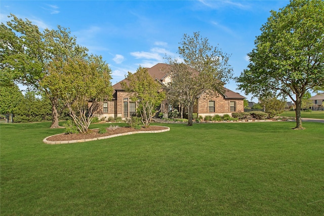 view of front of house with brick siding and a front yard