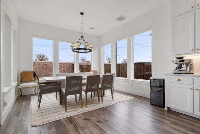 3340 Cabin Crest Pl, Frisco, TX 75033 - dining area featuring a chandelier, dark wood finished floors, beverage cooler, and baseboards