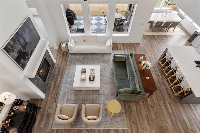 3340 Cabin Crest Pl, Frisco, TX 75033 - living area with wood finished floors, baseboards, and a glass covered fireplace