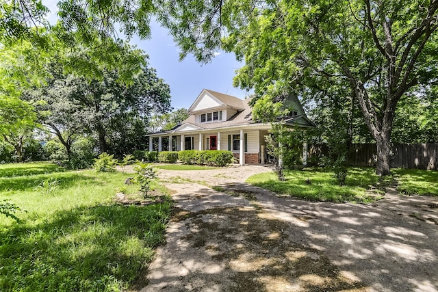 511 Highland Ave, Waxahachie, TX 75165 - view of front of home with fence, a porch, and brick siding
