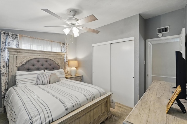 carpeted bedroom with a closet, ceiling fan, and visible vents