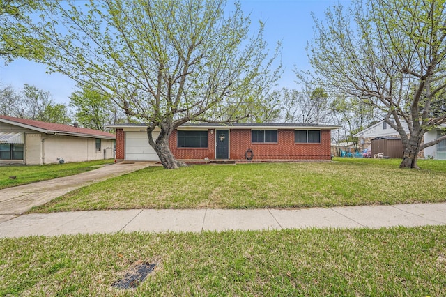 ranch-style house with an attached garage, concrete driveway, a front yard, and brick siding