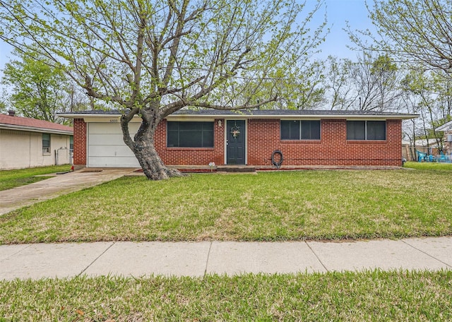 ranch-style home with an attached garage, concrete driveway, a front lawn, and brick siding