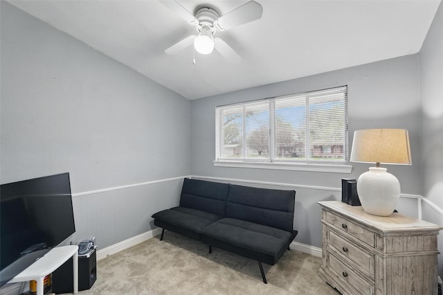 sitting room featuring ceiling fan, light colored carpet, baseboards, and vaulted ceiling