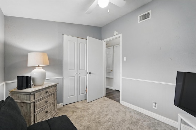 carpeted bedroom featuring baseboards, ceiling fan, a closet, and visible vents