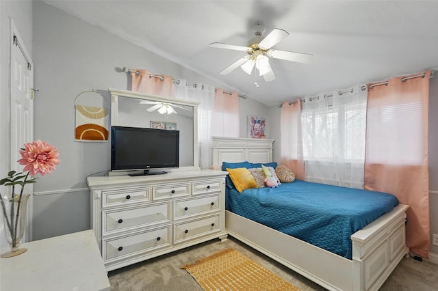 bedroom featuring a ceiling fan, carpet, and vaulted ceiling