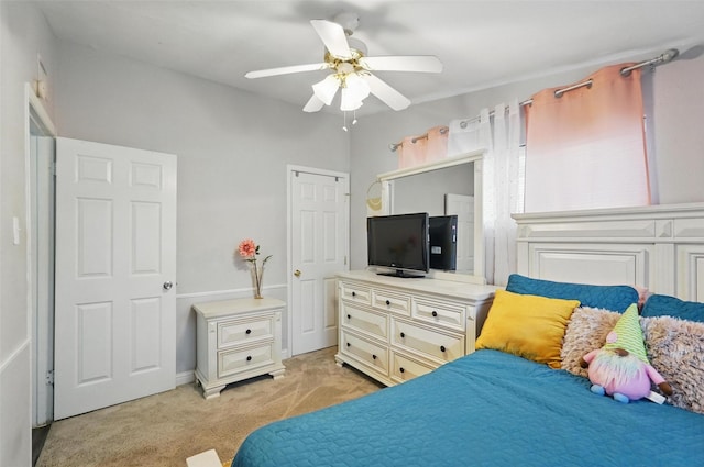 bedroom featuring light colored carpet and a ceiling fan