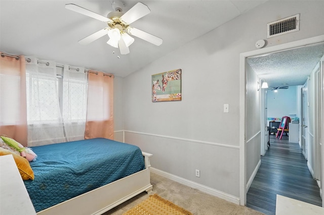 bedroom featuring baseboards, a ceiling fan, vaulted ceiling, and visible vents