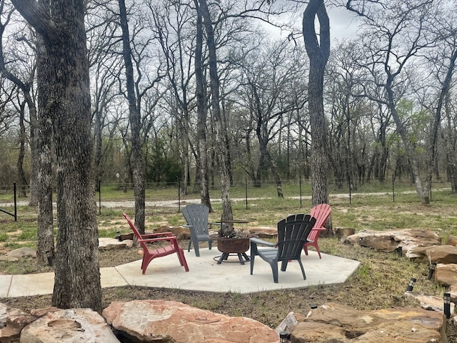 view of patio featuring a fire pit and fence