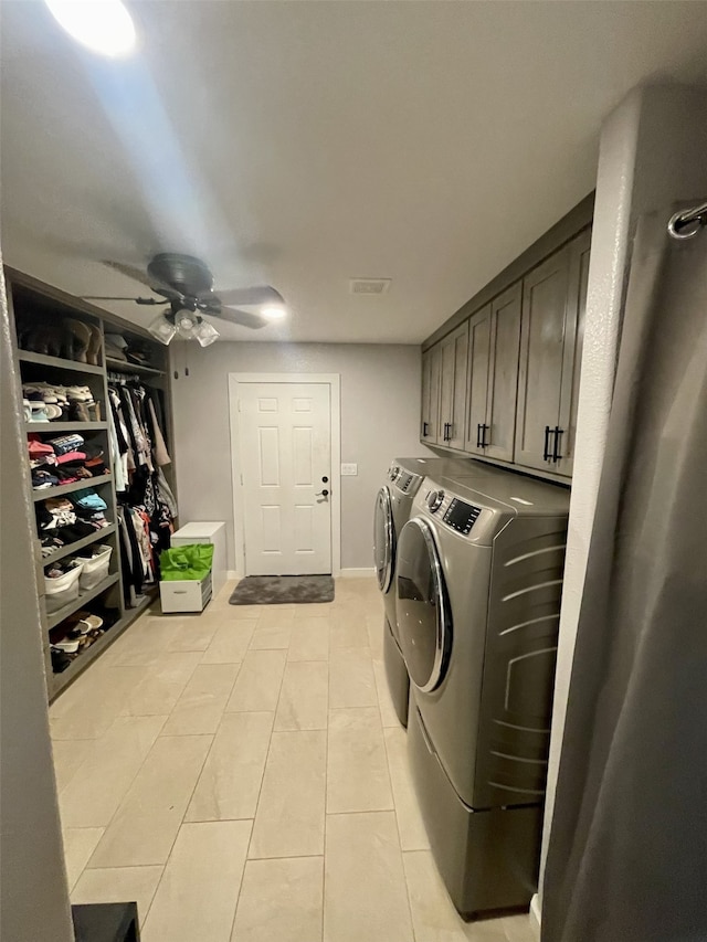 washroom with light tile patterned floors, visible vents, cabinet space, washer and dryer, and ceiling fan