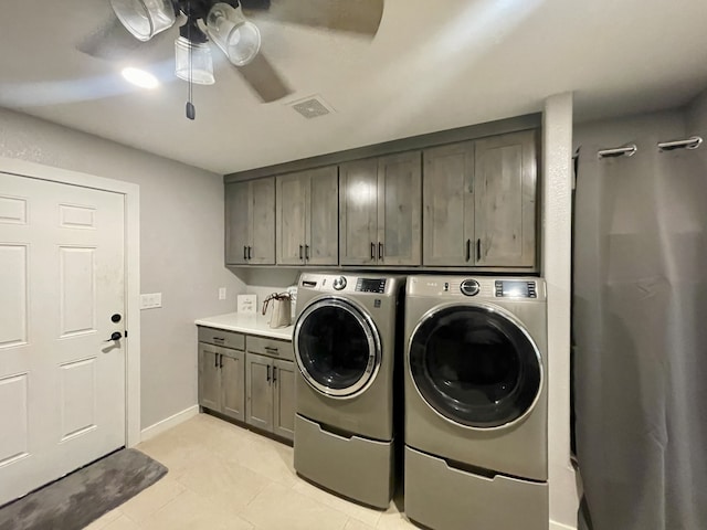 laundry room with a ceiling fan, separate washer and dryer, baseboards, visible vents, and cabinet space