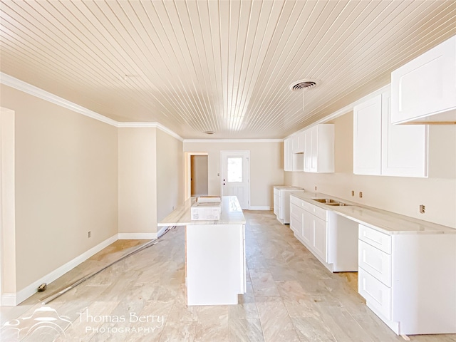 210 Wise St, Clyde, TX 79510 - kitchen with wood ceiling, white cabinets, visible vents, ornamental molding, and washer / dryer