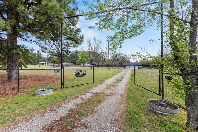 2223 Farm Rd Unit 115, Mount Vernon, TX 75457 - view of street featuring a gated entry and driveway