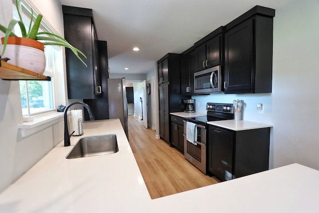 2432 Cottondale Rd, Springtown, TX 76082 - kitchen with appliances with stainless steel finishes, a sink, dark cabinetry, light countertops, and recessed lighting