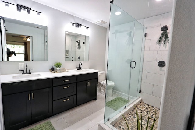 2432 Cottondale Rd, Springtown, TX 76082 - bathroom with a stall shower, double vanity, a ceiling fan, and toilet