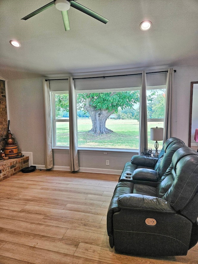 2432 Cottondale Rd, Springtown, TX 76082 - living room with a ceiling fan, a textured ceiling, light wood-style flooring, baseboards, and recessed lighting