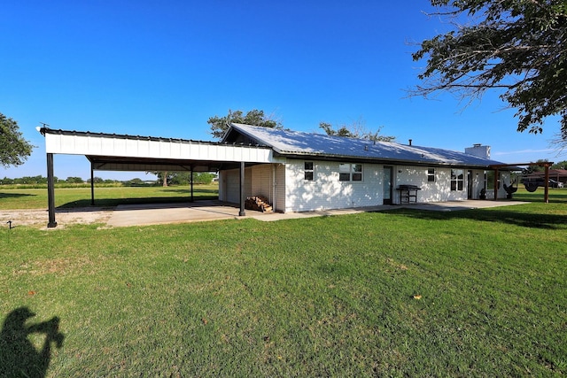 2432 Cottondale Rd, Springtown, TX 76082 - rear view of property featuring a yard, an attached carport, concrete driveway, and a chimney