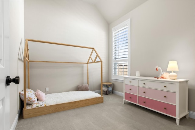 carpeted bedroom featuring baseboards, multiple windows, and vaulted ceiling