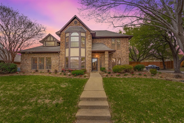 2505 Skipwith Dr, Plano, TX 75023 - view of front facade featuring roof with shingles, fence, brick siding, and a lawn