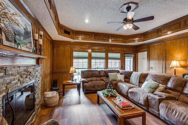 2505 Skipwith Dr, Plano, TX 75023 - living area with wood finished floors, a ceiling fan, a textured ceiling, visible vents, and wood walls