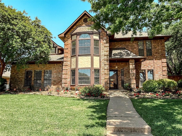 2505 Skipwith Dr, Plano, TX 75023 - view of front facade with brick siding, roof with shingles, and a front yard