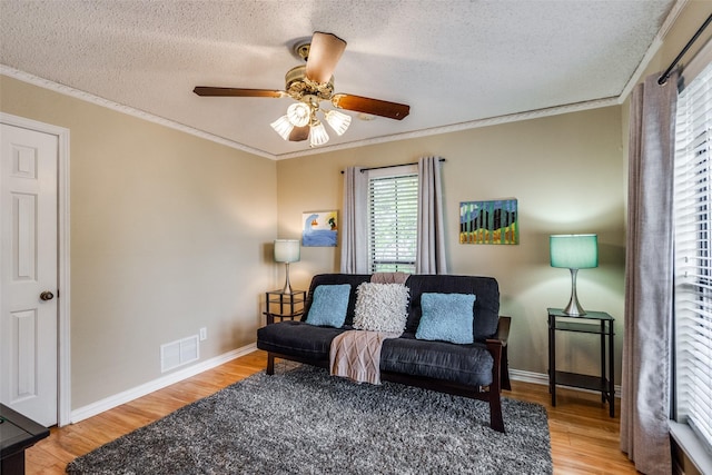 2505 Skipwith Dr, Plano, TX 75023 - living area with a textured ceiling, a wealth of natural light, visible vents, and wood finished floors