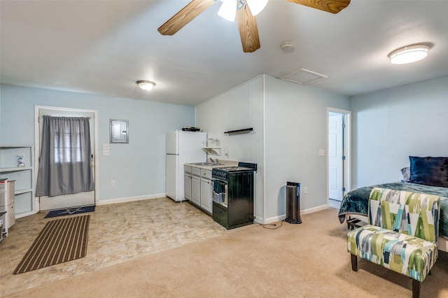 3929 Collinwood Ave, Fort Worth, TX 76107 - kitchen with freestanding refrigerator, black range with gas cooktop, a ceiling fan, a sink, and baseboards