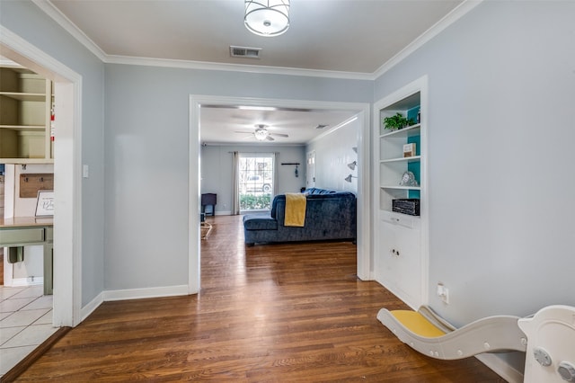 3929 Collinwood Ave, Fort Worth, TX 76107 - corridor with wood finished floors, crown molding, built in shelves, and baseboards