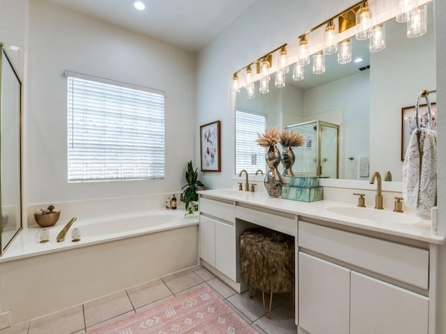bathroom with double vanity, a sink, a stall shower, and tile patterned flooring
