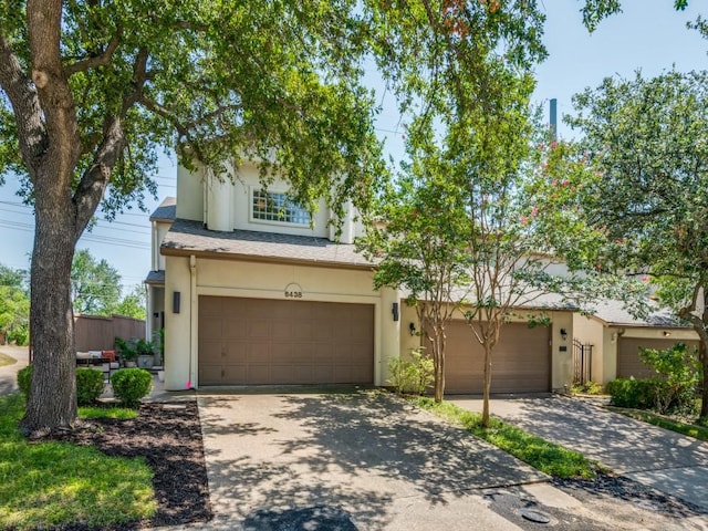 view of front of house with driveway, stucco siding, and a garage