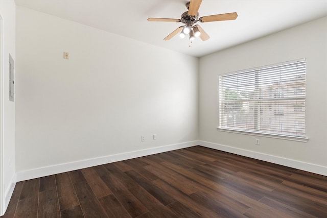 unfurnished room featuring dark wood-style flooring, ceiling fan, and baseboards