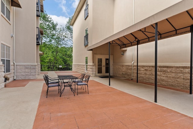 view of patio / terrace featuring outdoor dining space, french doors, and fence