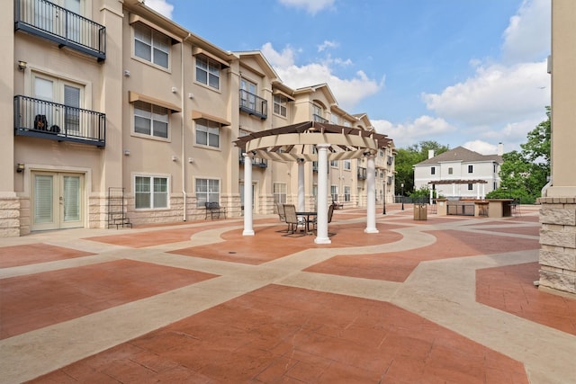 view of property's community with a residential view and a pergola