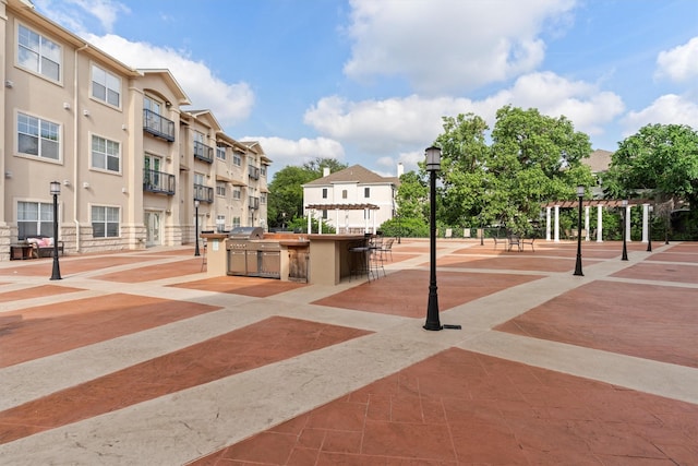 view of community featuring a pergola and outdoor dry bar