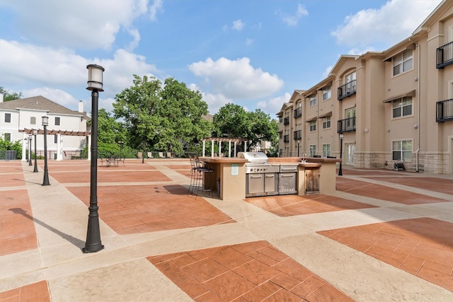 view of community featuring area for grilling and a pergola