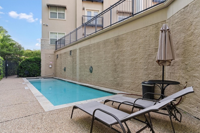 view of swimming pool with a patio, fence, and a fenced in pool