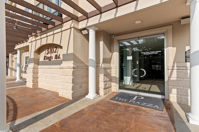 doorway to property featuring stucco siding