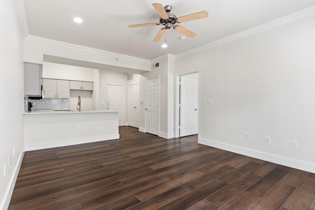 unfurnished living room with crown molding, a ceiling fan, visible vents, and dark wood-style flooring