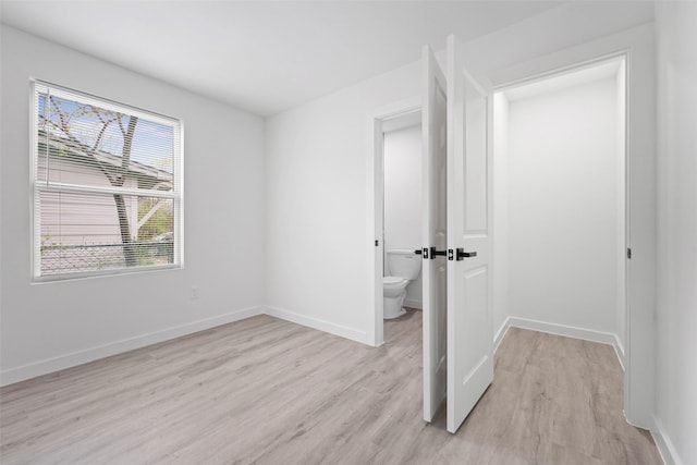 11534 Fernald Ave, Dallas, TX 75218 - unfurnished bedroom featuring light wood finished floors and baseboards